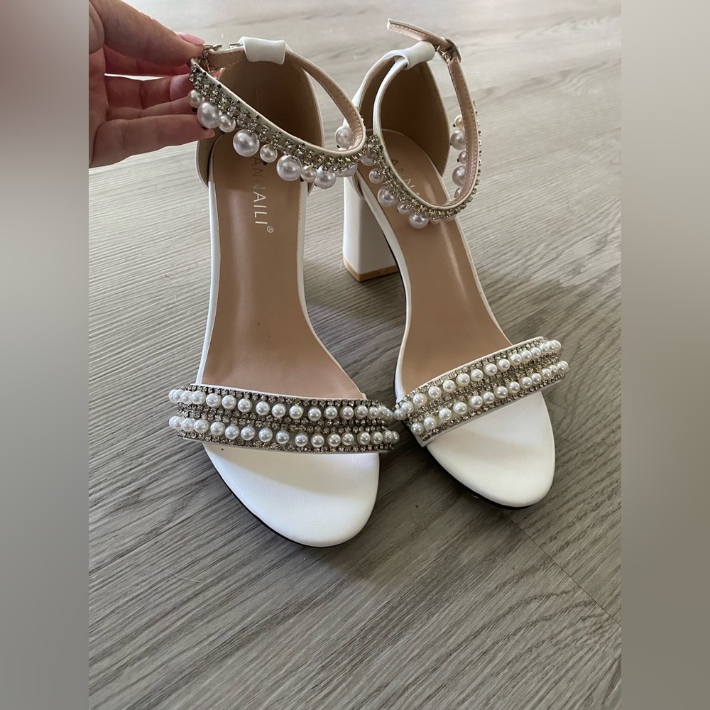White heels with pearl accents